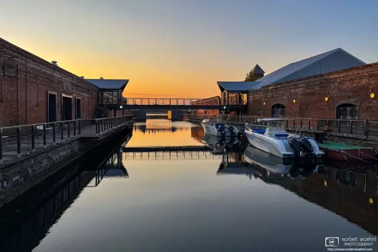 A peaceful scene at dusk in the Kanemori Red Brick Warehouse district of Hakodate in Hokkaido, Japan. The warehouses trace their origins to 1869.