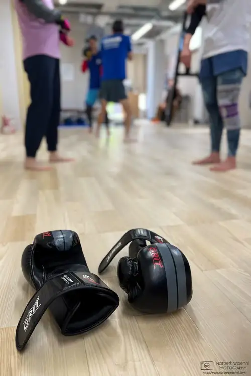 At the kickboxing gym this morning, before wearing my gloves for the sandbag punching practice, I captured this discreet action shot of some other members.