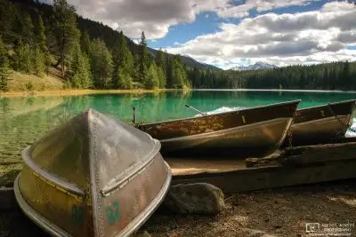 Boats are waiting along a lake shore in the Valley of Five lakes in Jasper National Park, Alberta, Canada.