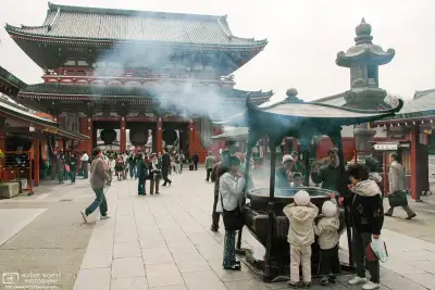 Visitors are burning incense on the premises of Senso-ji Temple in Asakusa, Tokyo.