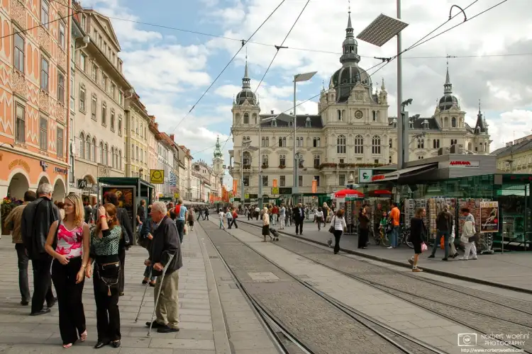 A lively scene from the Hauptplatz (Main Square) in the historic city center of Graz, Austria.