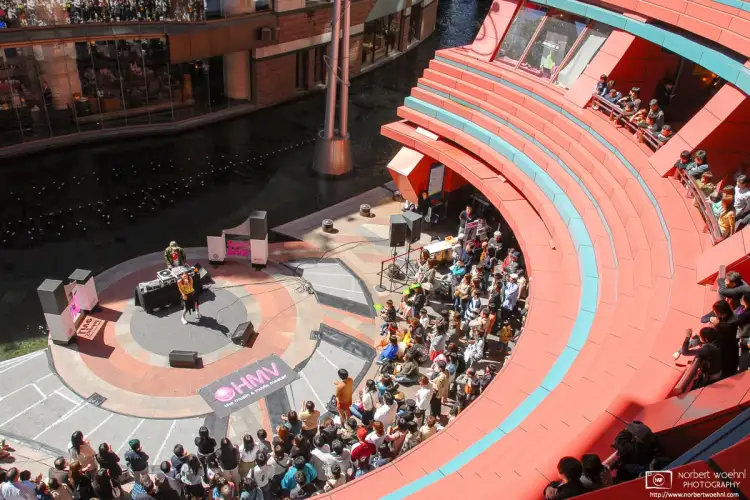 At the Canal City Hakata shopping complex in Fukuoka, Japan, people are listening to a live performance by pop singer Naomi Yoshimura.