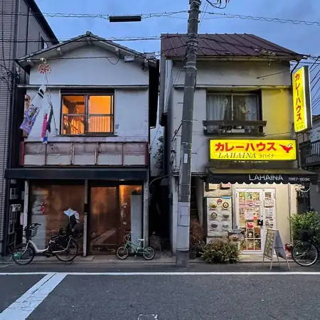Two buildings in the Azusawa district of Itabashi Ward in Tokyo, Japan. On the right is a Curry Restaurant, on the left is a residential building.
