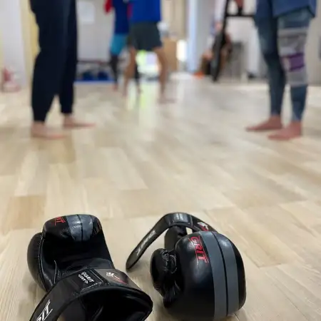 At the kickboxing gym this morning, before wearing my gloves for the sandbag punching practice, I captured this discreet action shot of some other members.