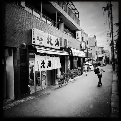 People are walking past local restaurants in the Shimizucho area of Itabashi Ward in Tokyo, Japan.