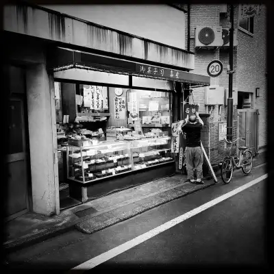 The owner of a confectionery shop in the Shimizucho area of Itabashi Ward in Tokyo, Japan, is preparing to close for the day.