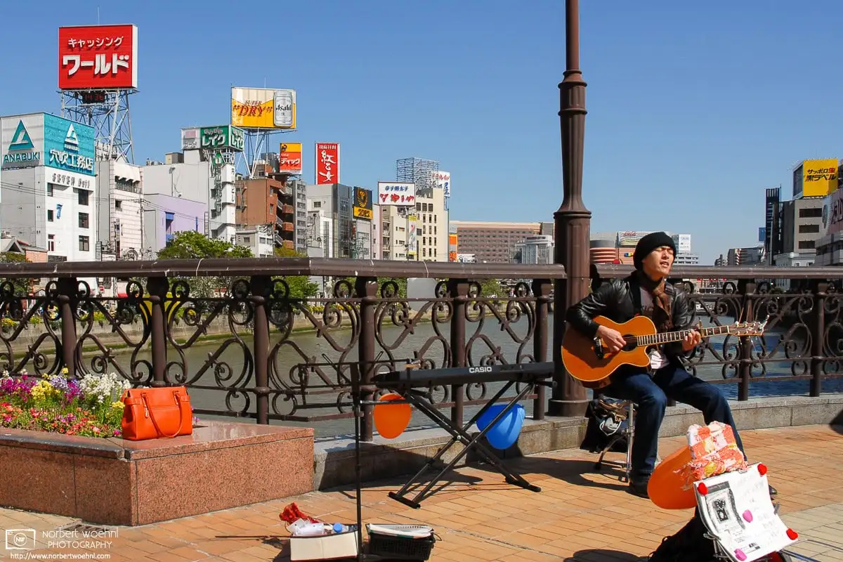 Street musician along the Naka River in Fukuoka, Japan.