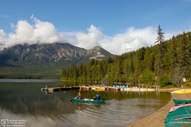 On a fine day, visitors are embarking on a canoe tour of Pyramid Lake in Jasper National Park, Alberta, Canada.