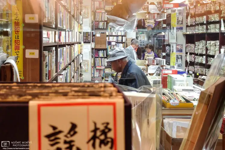View through the window into a used-books store in Jimbocho, Tokyo, Japan. The area has dozens of vintage bookshops filled with interesting publications.