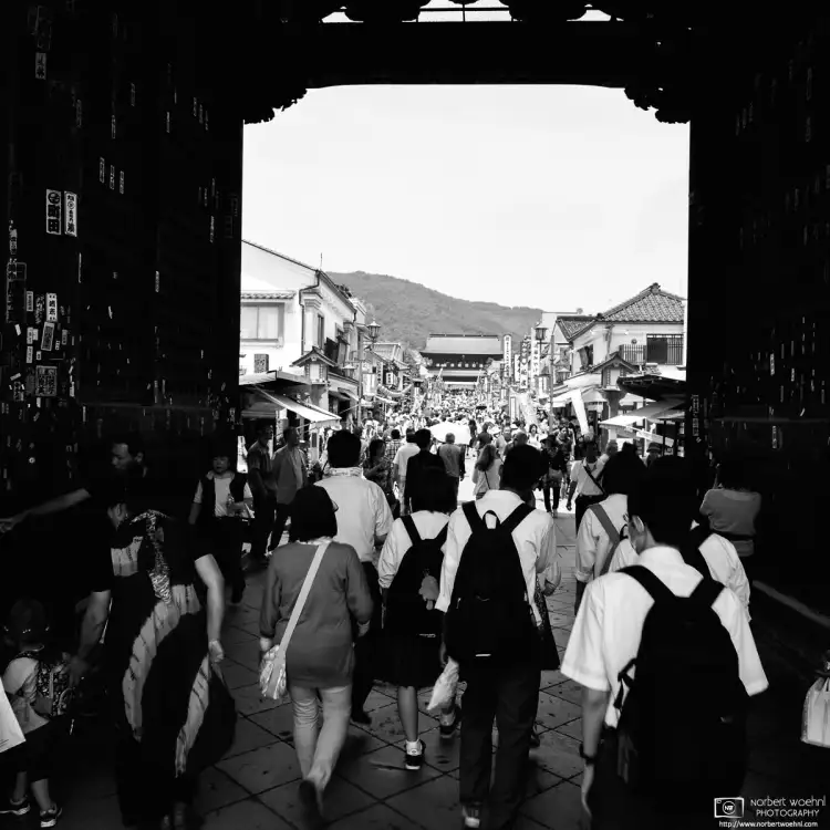 Along the approach to Zenkoji Temple in Nagano, Japan, visitors are passing through the Niomon Gate.