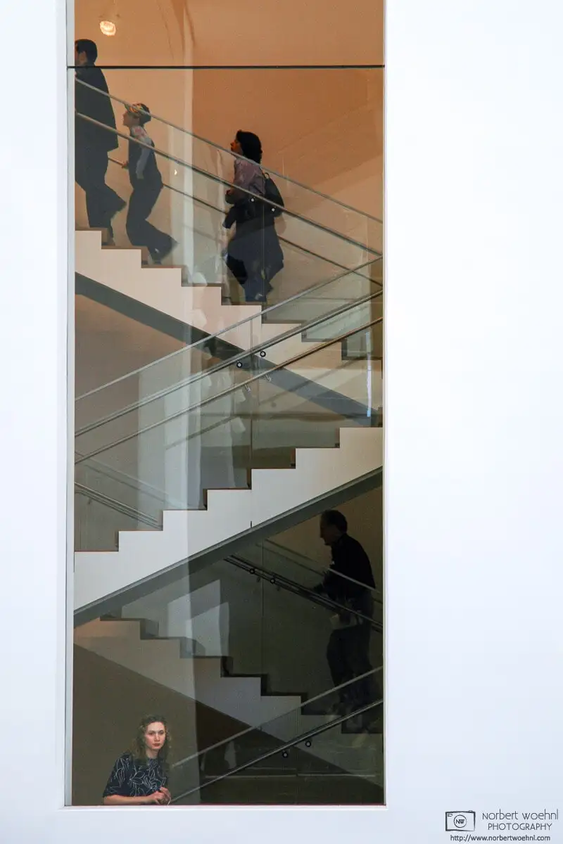 A visitor looks through a window at the Museum of Modern Art (MoMA) in New York City.