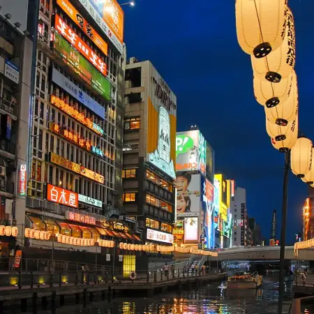An evening perspective along the Dōtonbori Canal in Osaka, Japan. Historically a theater district, Dotonbori is now a popular nightlife and entertainment area.