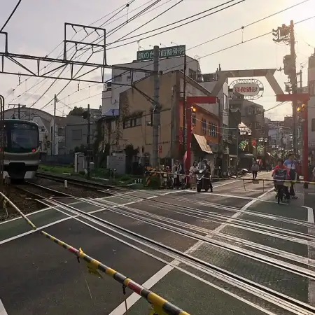 Afternoon scene at a typical street-level railway crossing in the Hatanodai area of Shinagawa Ward in Tokyo, Japan.