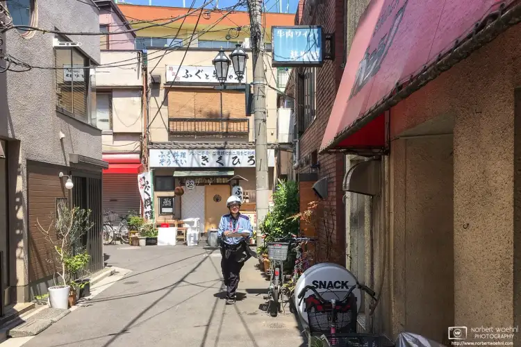 The postman is coming to this old corner in the Takinogawa area of Kita Ward in Tokyo, Japan.