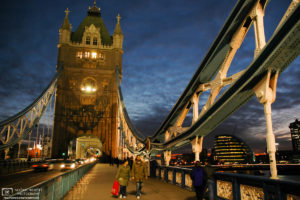 An evening walk across Tower Bridge in London, England. The City Hall (GLA Building) is visible in the background.