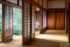 A visitor is seen reading between sliding doors outside a tatami room at Kenninji Temple in Kyoto, Japan.