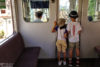 Kids enjoying the driver's perspective while riding a Kintetsu Line train in Kyoto, Japan.
