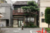 An old woman walking through a residential neighborhood in Taito-ku, Tokyo, Japan.