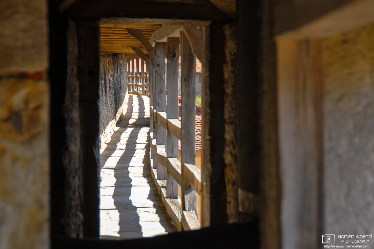 A view into the pedestrian corridor of the historic town fortification wall in Rothenburg ob der Tauber, Germany.
