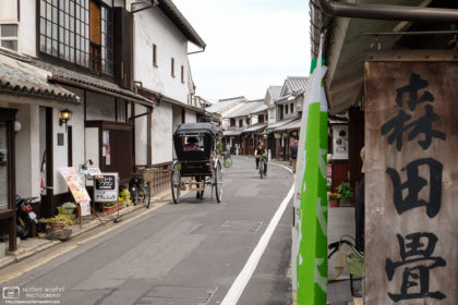Light traffic in a side street of the historic district of Kurashiki in Okayama Prefecture, Japan.