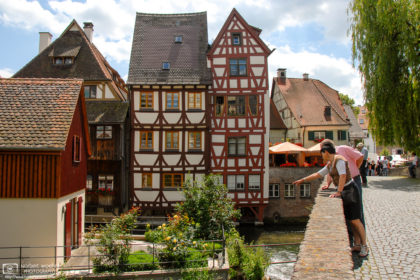 Visitors enjoying the view from Häuslesbruck in the historic Fisherman's Quarter (Fischerviertel) in Ulm, Germany.