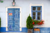 Multiple layers of blue paint on a beautiful exterior of an old pub at St. Margarethen in Burgenland, Austria.