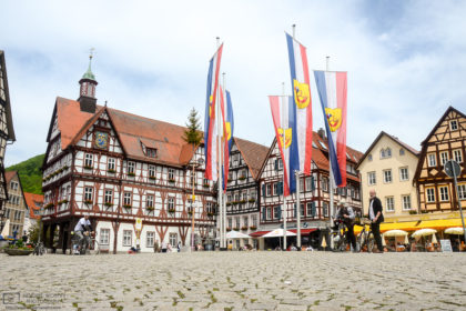 Cyclists enjoying a fine spring day on the historic Market Square of Bad Urach in Southwestern Germany.