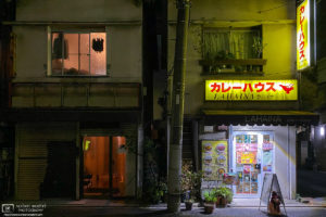An evening view of the 'Curry House Lahaina', and a slightly mysterious adjacent building, in the Azusawa neighborhood of Itabashi-ku, Tokyo, Japan.