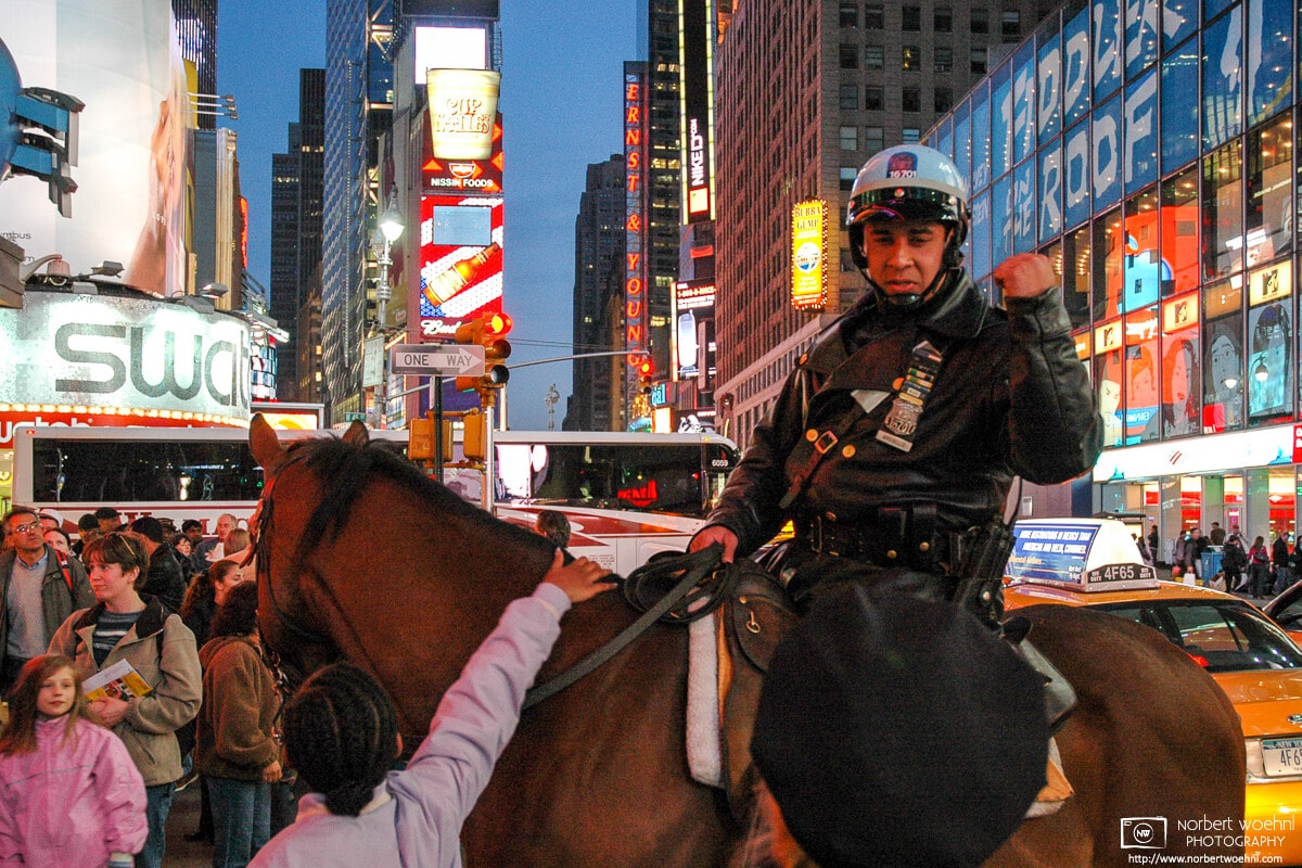 A policeman is seen navigating early-evening traffic on top of a horse on Times Square in New York City, USA.