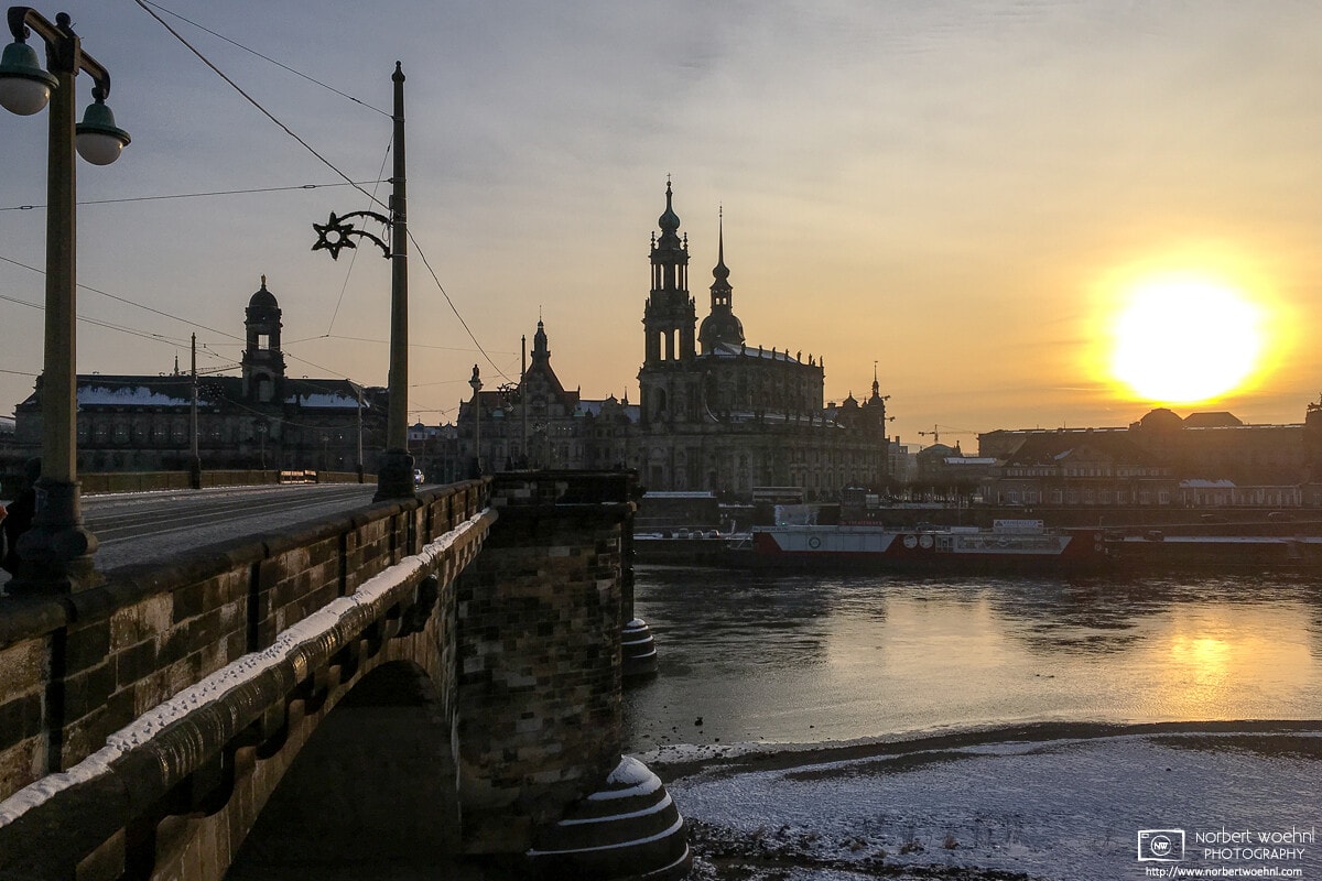 A winter view of Augustus Bridge spanning the Elbe River into the old town of Dresden, Germany.