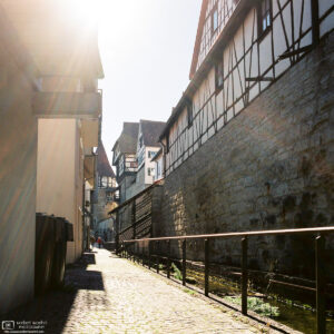 Bright rays of sunlight at Little Venice, a pleasant area along the old town wall of Balingen, Germany.
