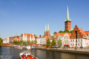 A view towards the old city center of Lübeck, Germany, from a tour boat on the Trave River.