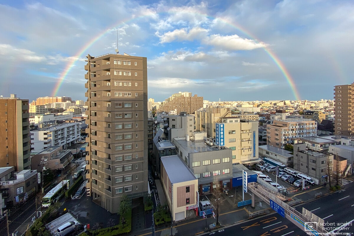 Towards the end of a rain-filled day, a rainbow rises over the eastern part of Itabashi-ku in Tokyo, Japan.