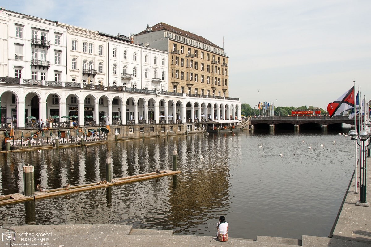 Near the City Hall of Hamburg, Germany, visitors can soak in this splendid view across the Alsterfleet, with the historic Alsterarkaden shopping arcade visible at the left.