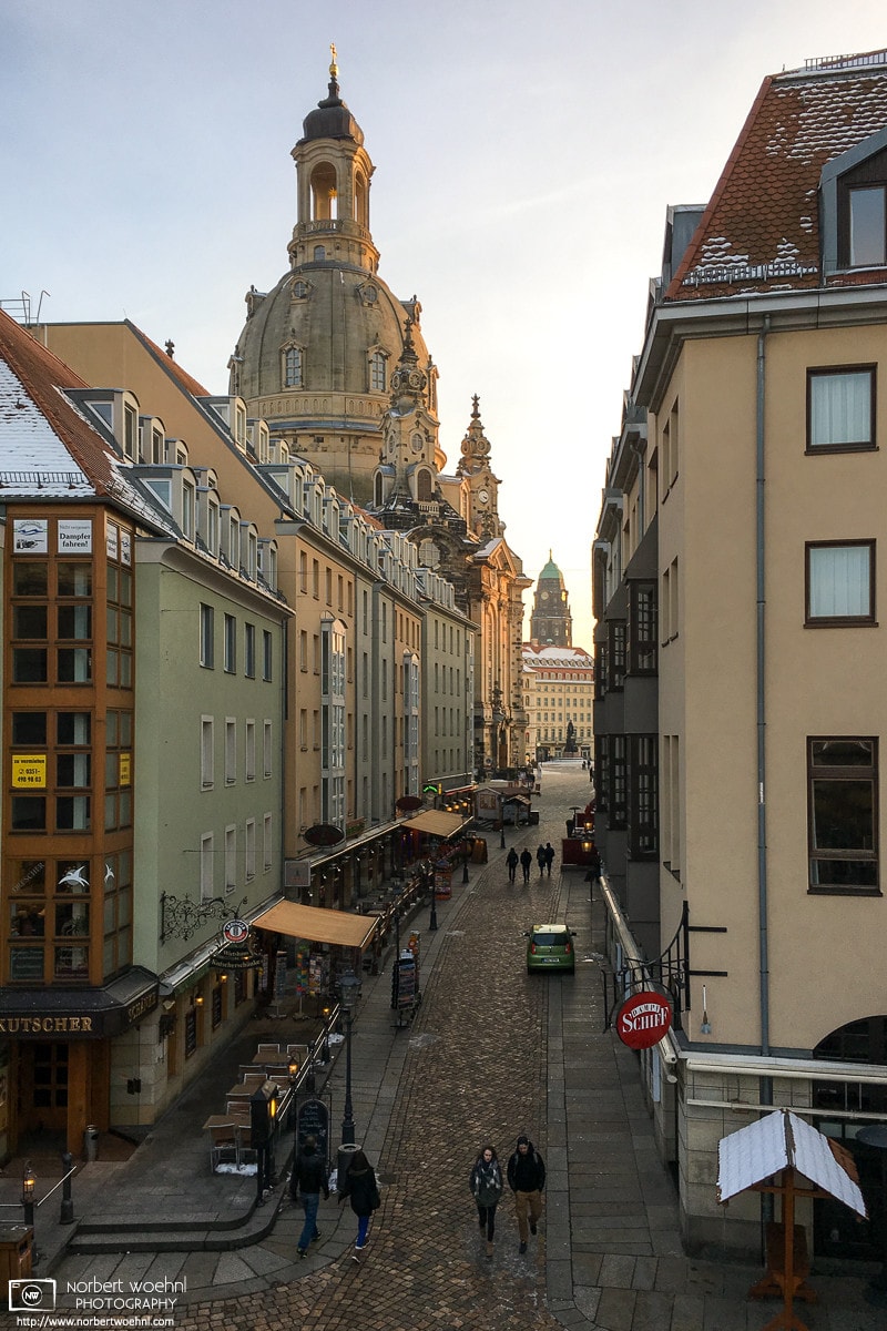 A southbound view along Münzgasse towards the dome of Frauenkirche in Dresden, Germany. The darker tower in the back is part of the new City Hall (Neues Rathaus).