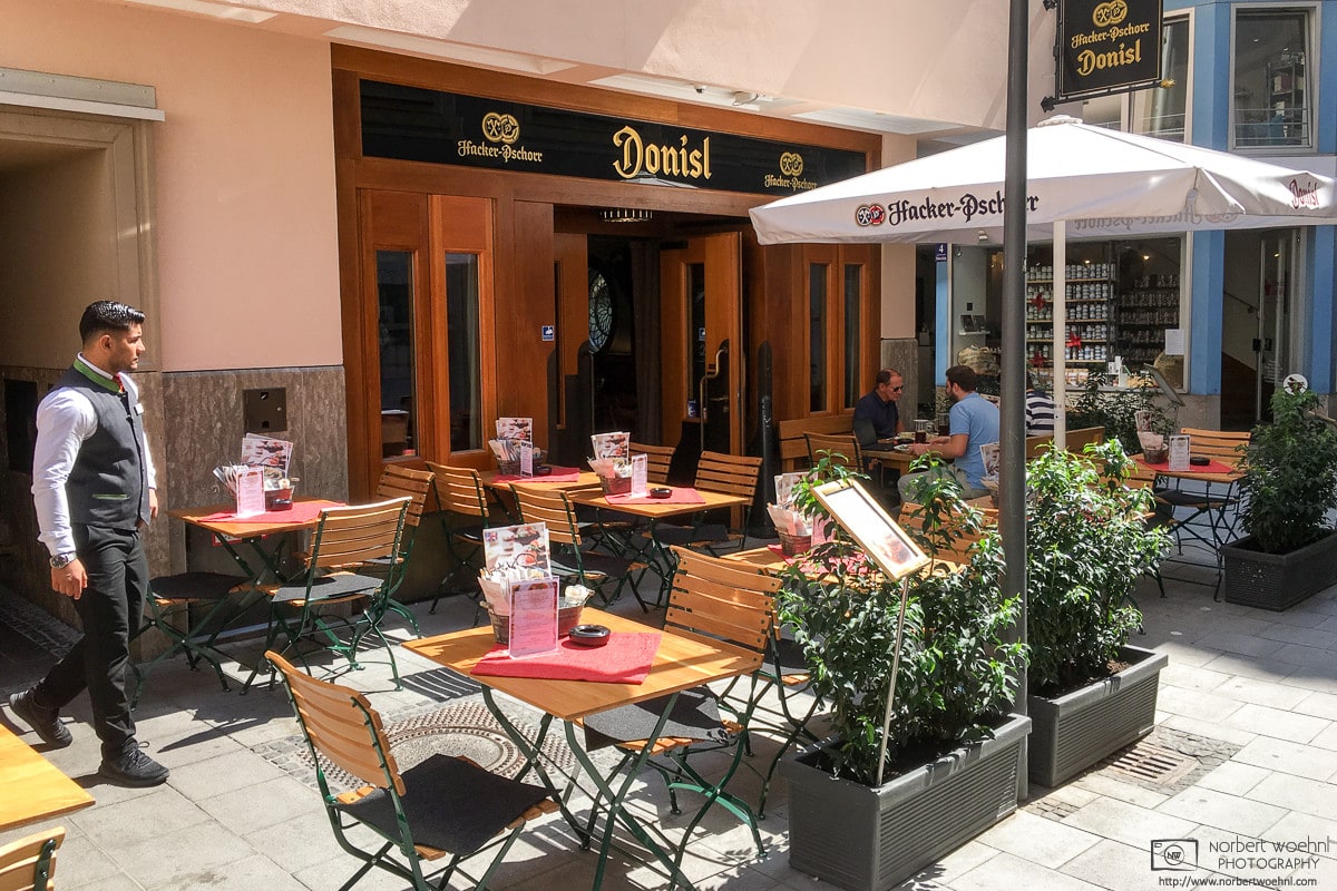 A summer scene at the traditional Donisl restaurant in the historic city center of Munich, Germany.