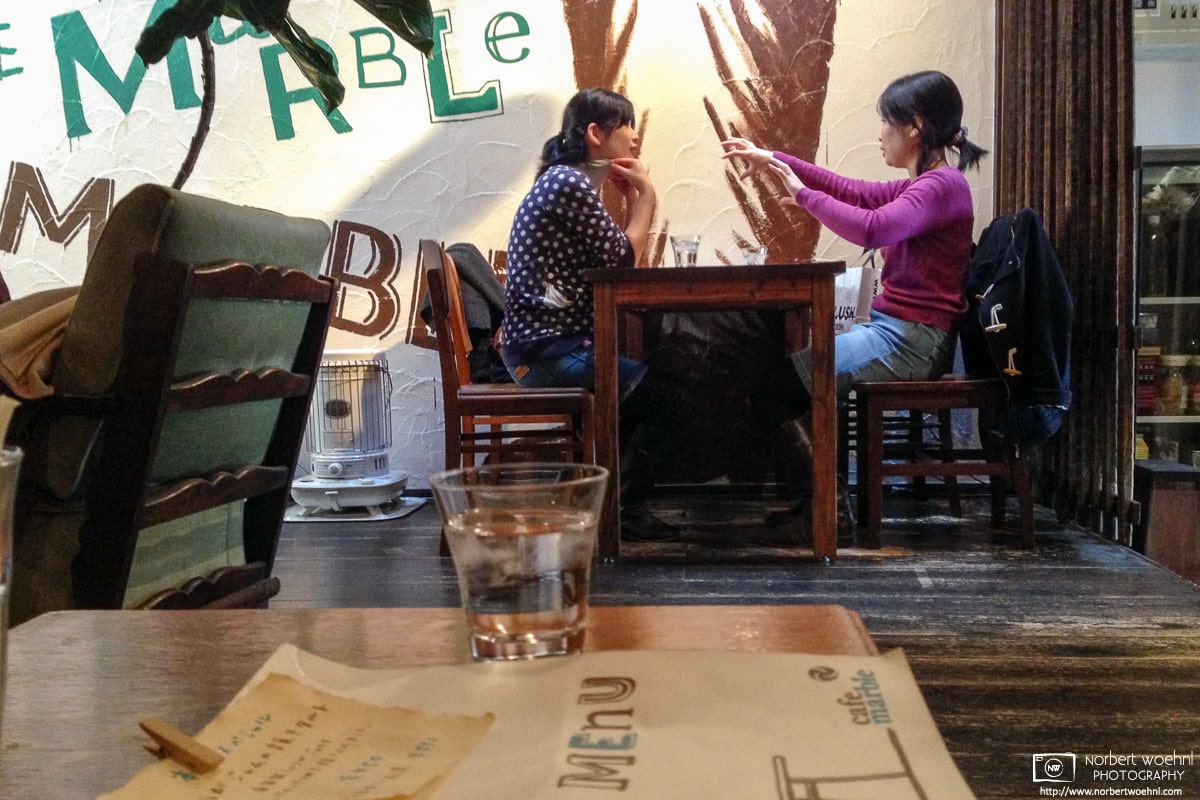 At the delightful Cafe Marble in Kyoto, Japan, two customers are enjoying a relaxing conversation.