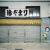 At Gondo Shopping Street in Nagano, an advertisement mural is painted on the wall beside an old shop.