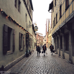 Musicians are walking along Heugasse in Rothenburg ob der Tauber, Germany, on their way to a Christmas season performance.