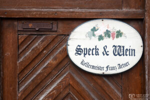 A sign advertising the sale of bacon and wine ("Speck & Wein") in the village of Sankt Margarethen in eastern Austria.