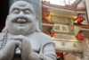 A statue of a laughing Buddha greets visitors at the entrance to the Chinatown of Kobe, Japan.