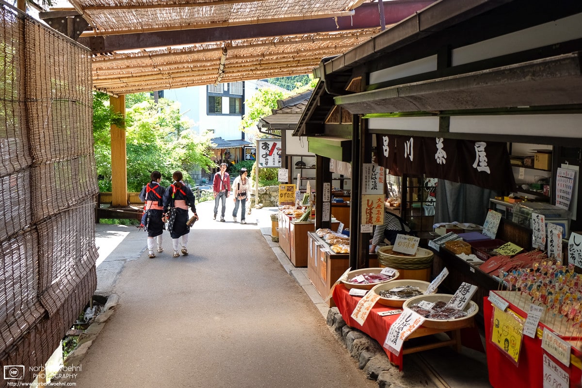 The approach to Sanzen-in Temple in Ohara, Kyoto, Japan is lined with shops selling souvenirs and a variety of food items.