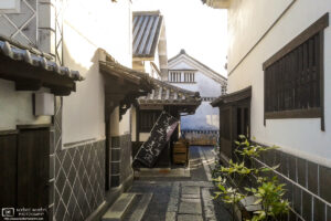A glimpse between some of the beautiful old warehouse buildings in the Bikan District of Kurashiki, Japan.
