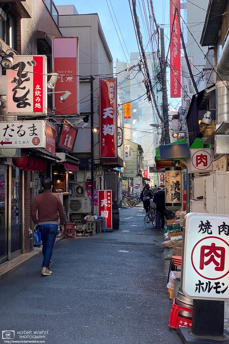 View along a lane of pubs and restaurants in the Kameido area of Koto Ward in Tokyo, Japan.
