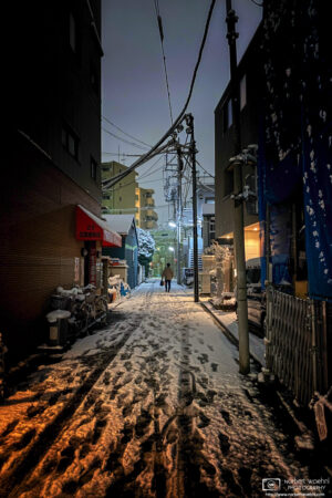 View of a residential side street after a surprise snowfall in Itabashi-ku, Tokyo, Japan.
